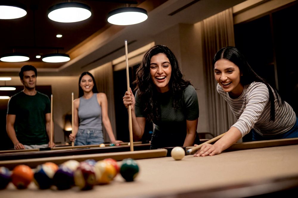 Friends laughing together around a billiards table in the clubhouse